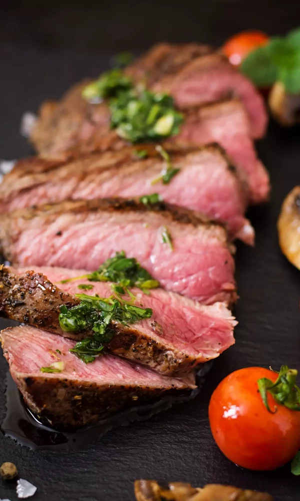 Juicy steak medium rare beef with spices and grilled vegetables.